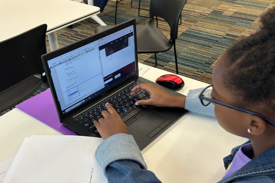 Girls Code Savannah Summer camp student coding a UI/UX component of the Foiled Pretty website