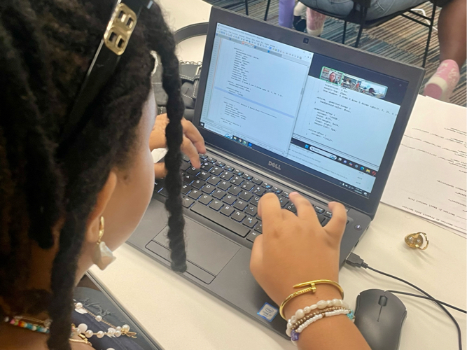 Girls Code Savannah Summer camp student adding CSS selectors and properties to the Foiled Pretty website code